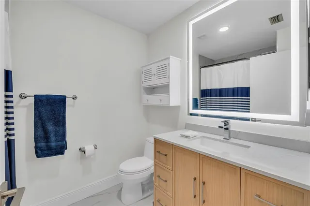 a patio with glass top table and chairs