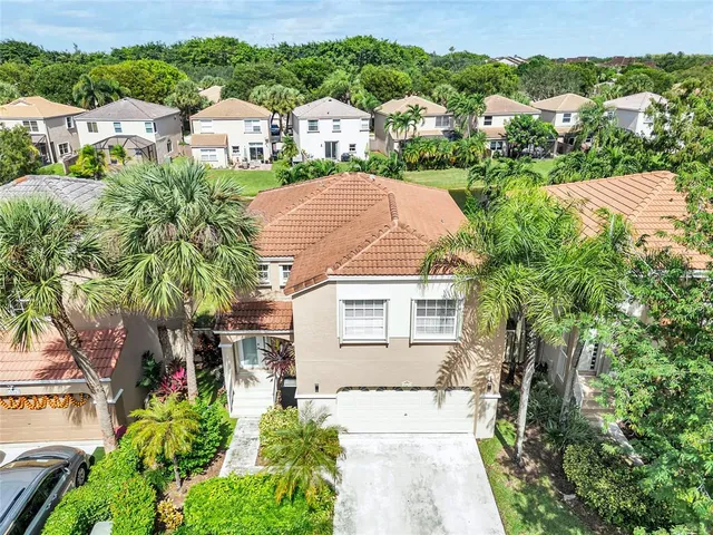 an aerial view of a house with swimming pool and garden space