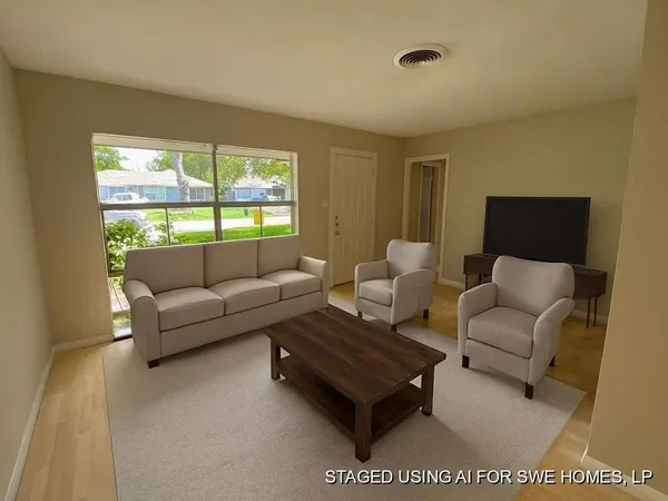 a living room with furniture and a large window