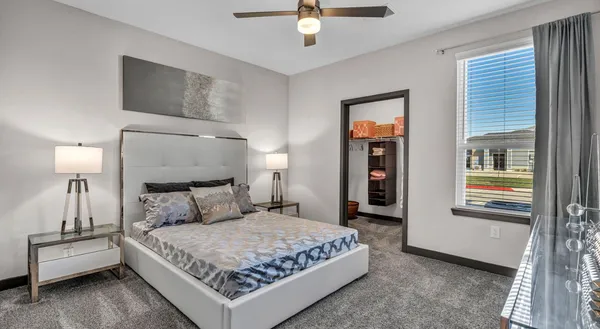 a bedroom with a bed and a window