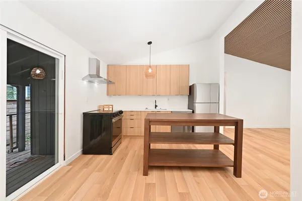 a kitchen with stainless steel appliances granite countertop a sink stove and cabinets