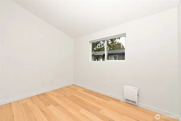 a view of a room with a wooden floor and a window