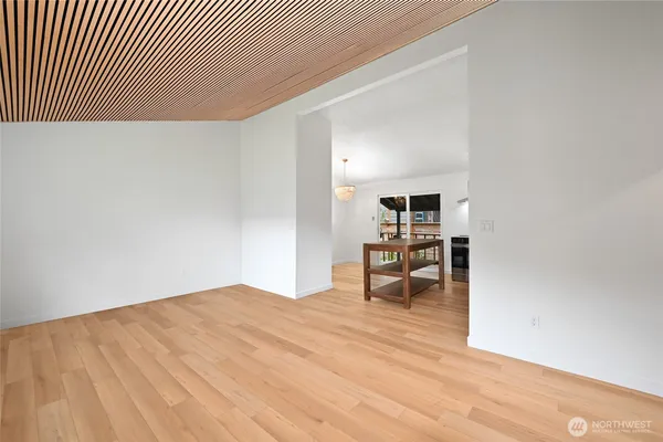 an empty room with wooden floor and furniture