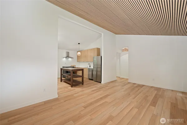 a view of empty room with wooden floor