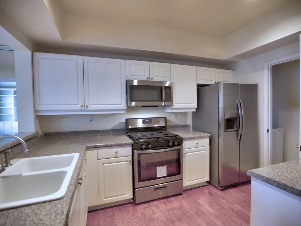 3636 Habersham Road Northwest, Unit 2308 Atlanta, GA 30305 - Photo 7 of 42 a kitchen with a sink stove and refrigerator