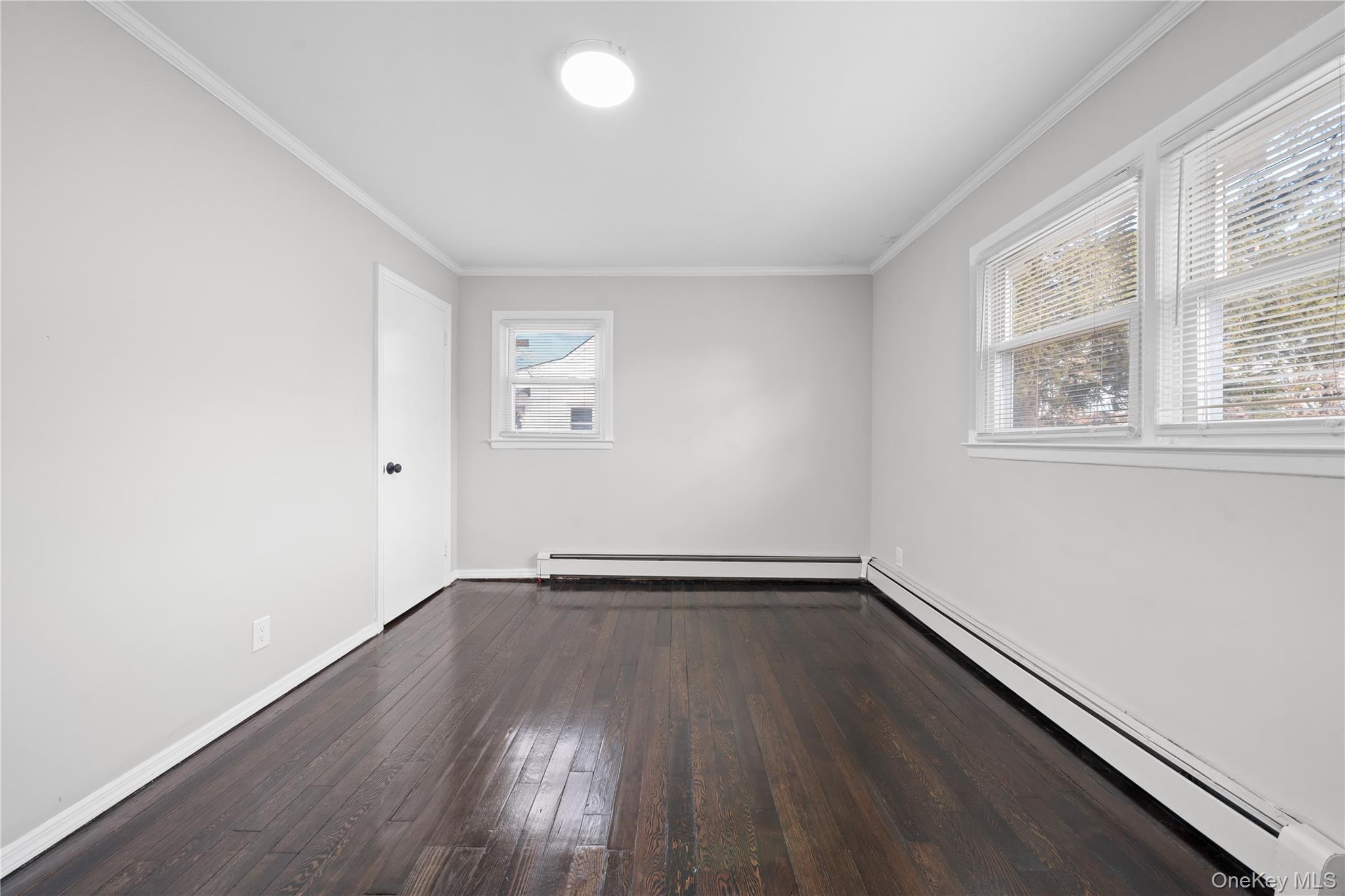 193 North Arizona Road West Babylon, NY 11704 - Photo 11 of 37 an empty room with wooden floor and windows