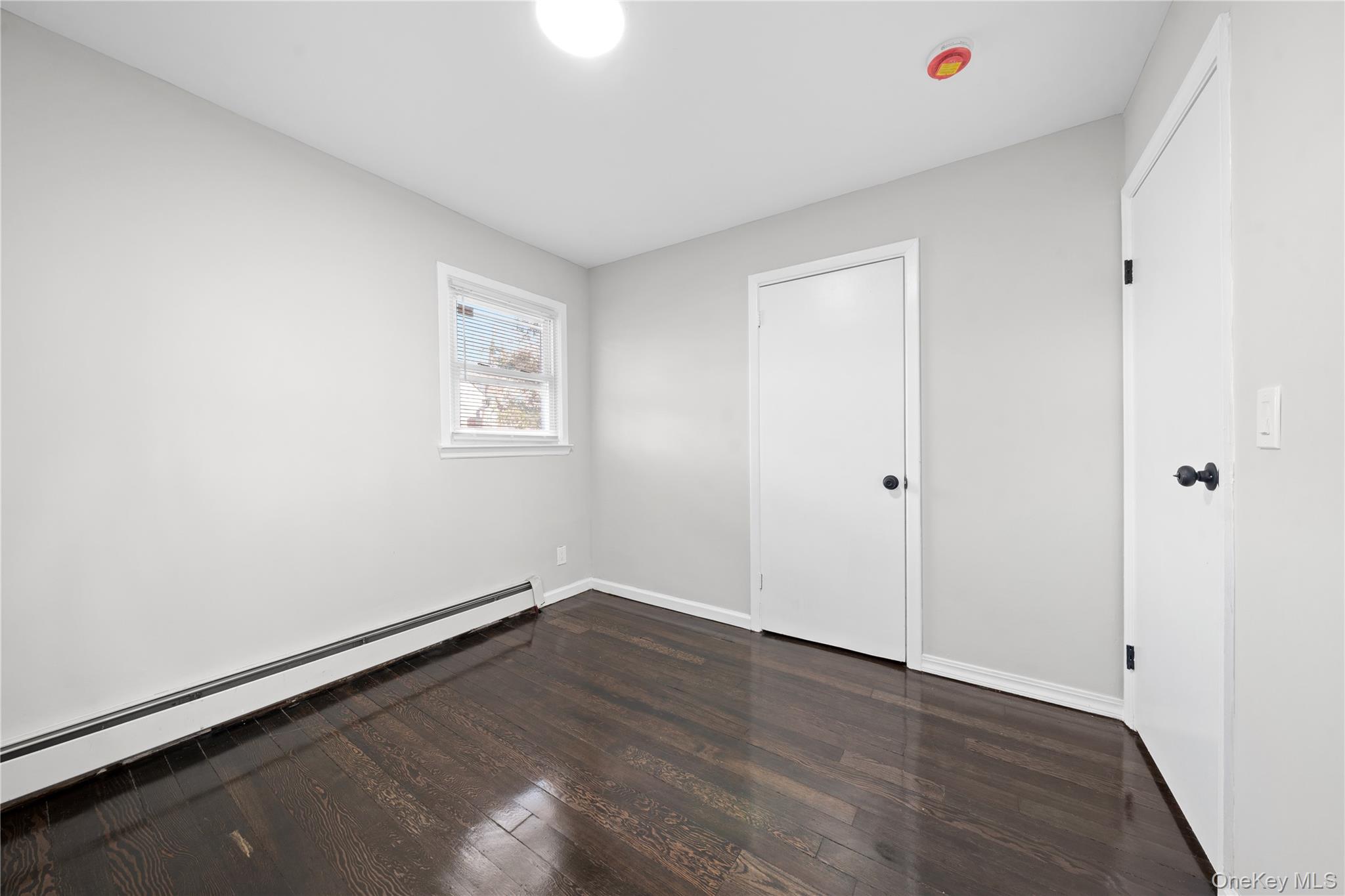 193 North Arizona Road West Babylon, NY 11704 - Photo 13 of 37 an empty room with wooden floor and windows