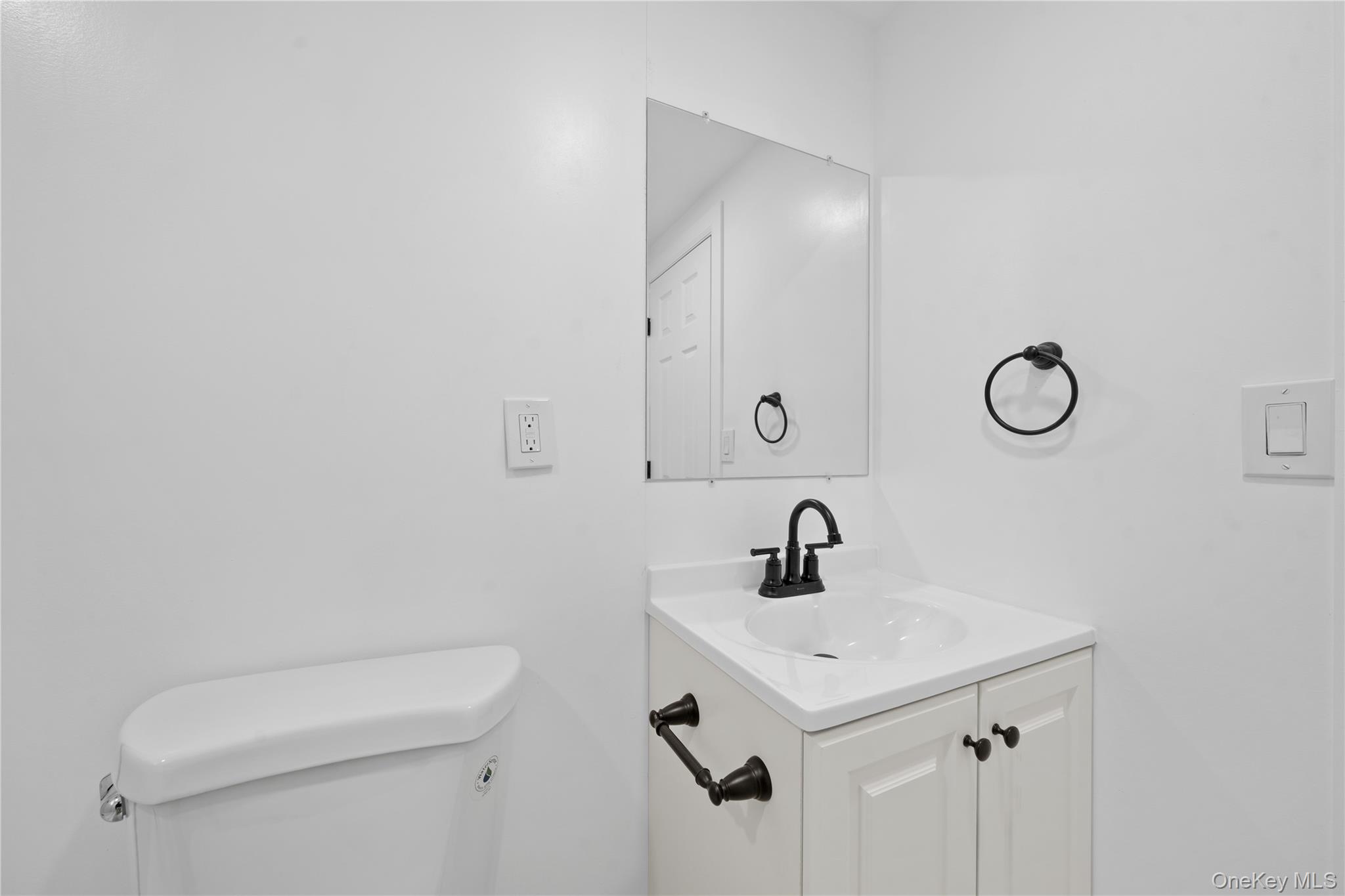 193 North Arizona Road West Babylon, NY 11704 - Photo 25 of 37 a bathroom with a sink a toilet and a mirror