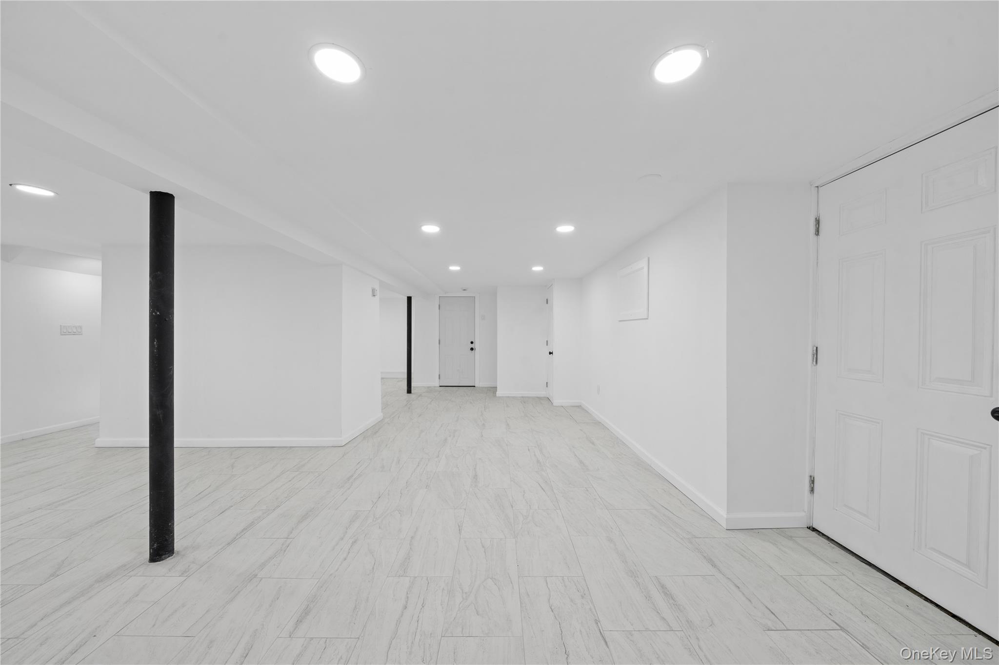193 North Arizona Road West Babylon, NY 11704 - Photo 29 of 37 an empty room with wooden floor and windows