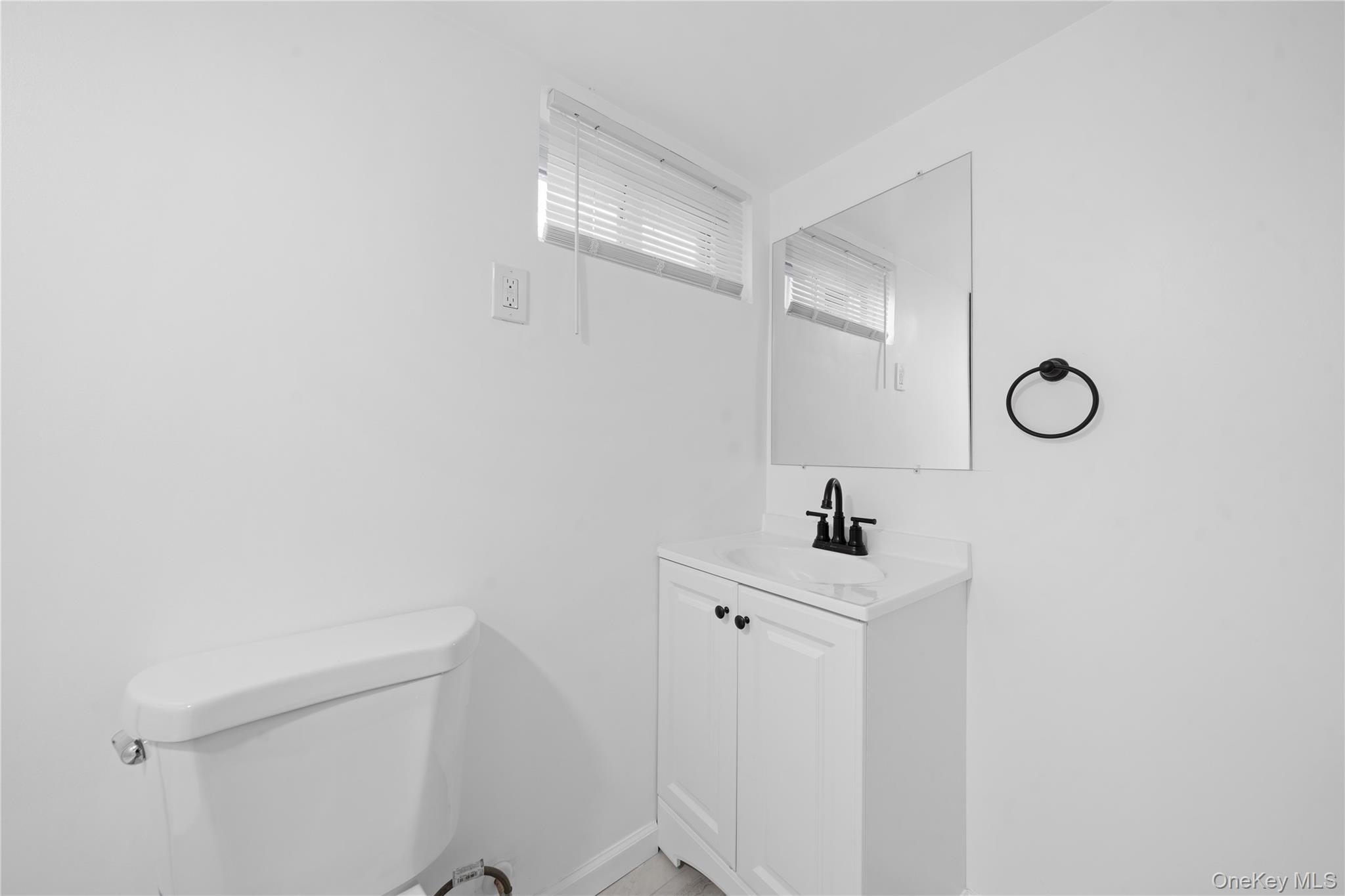 193 North Arizona Road West Babylon, NY 11704 - Photo 31 of 37 a bathroom with a sink and mirror