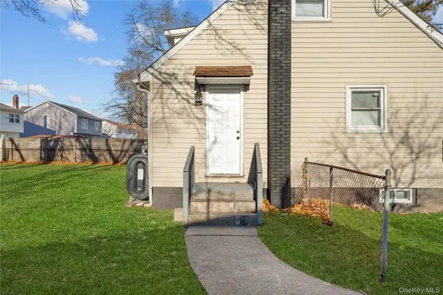 a front view of house with a garden