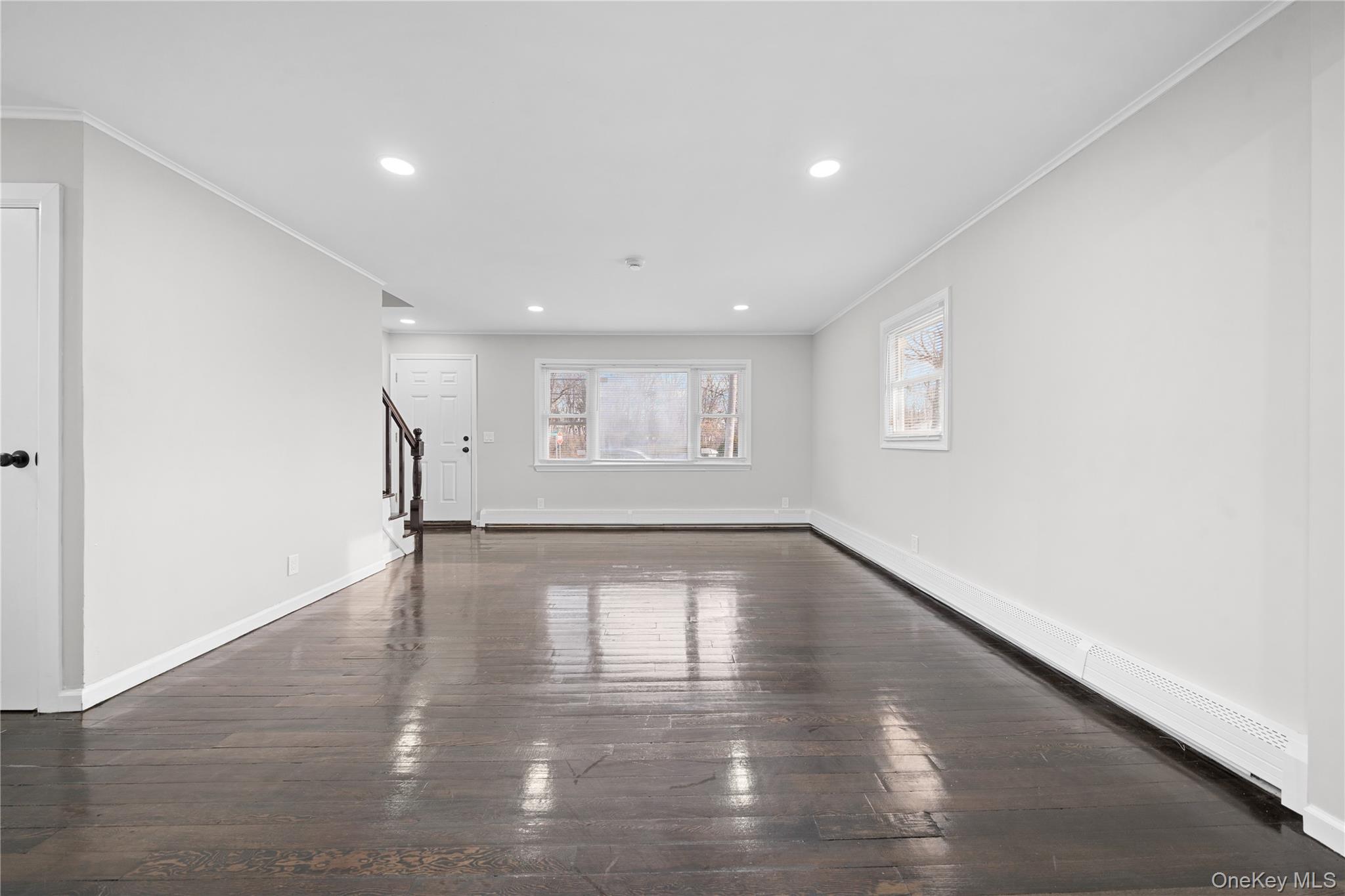 193 North Arizona Road West Babylon, NY 11704 - Photo 7 of 37 a view of an empty room with wooden floor and a window