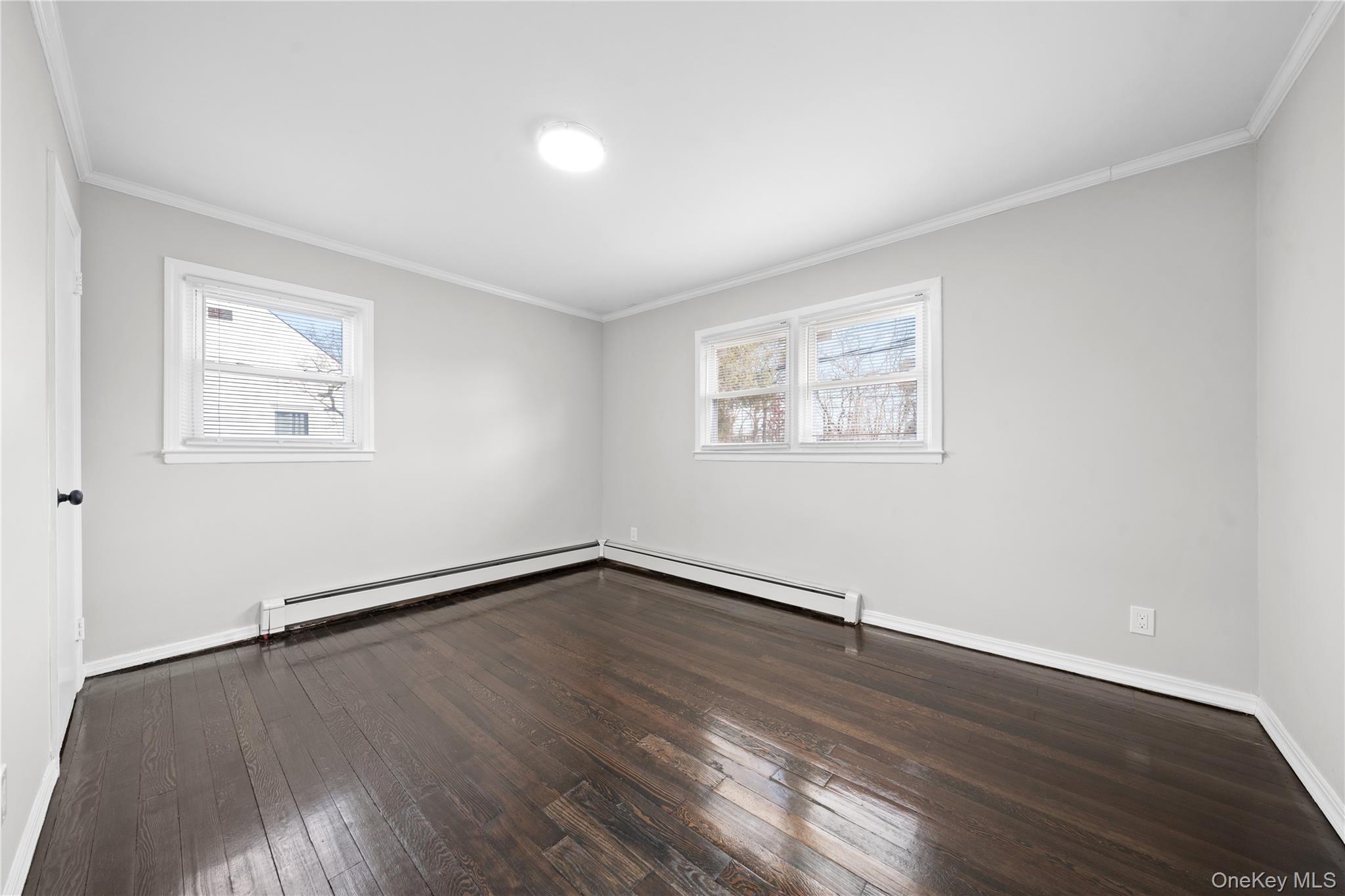 193 North Arizona Road West Babylon, NY 11704 - Photo 9 of 37 an empty room with wooden floor and windows