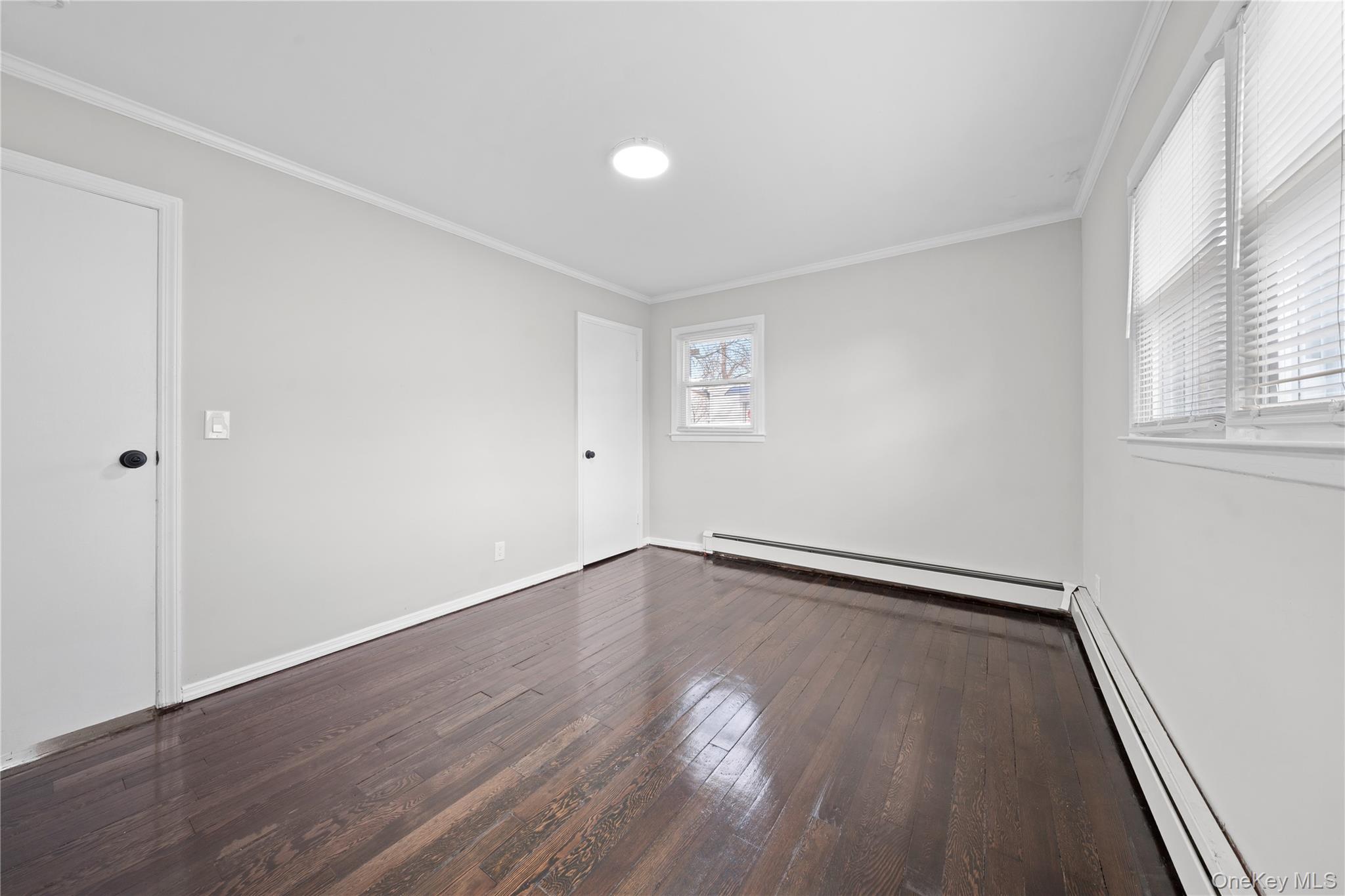 193 North Arizona Road West Babylon, NY 11704 - Photo 10 of 37 a view of an empty room with wooden floor and a window