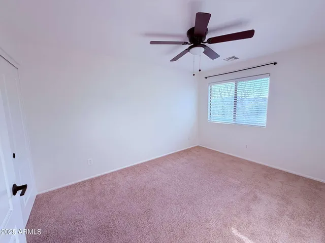 a view of room with a ceiling fan and window