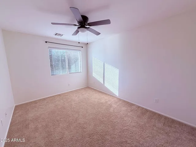 a view of an house with backyard space and balcony