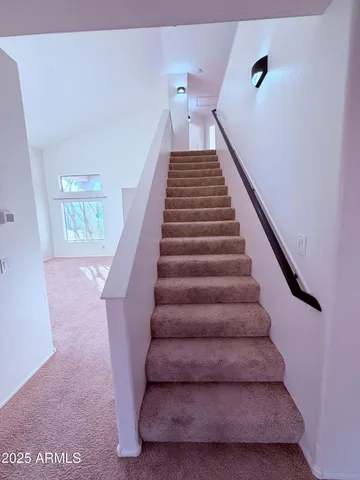 a view of a livingroom with a ceiling fan and window