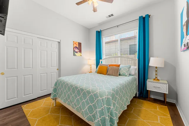 a view of a room that has a bed and dresser