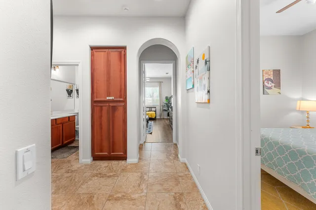 a bedroom with a bed and a chandelier