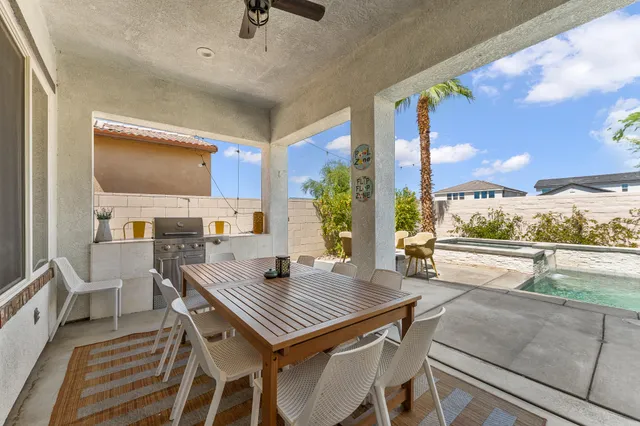 a view of a house with backyard porch and sitting area