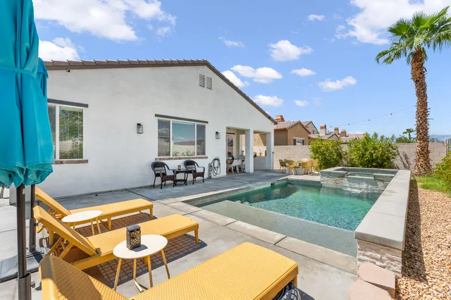 a view of a chairs and table on the patio