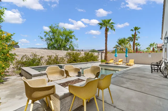 a front view of a house with a yard and potted plants