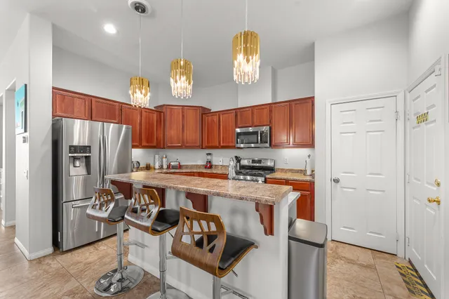 a kitchen with stainless steel appliances granite countertop a sink stove and refrigerator