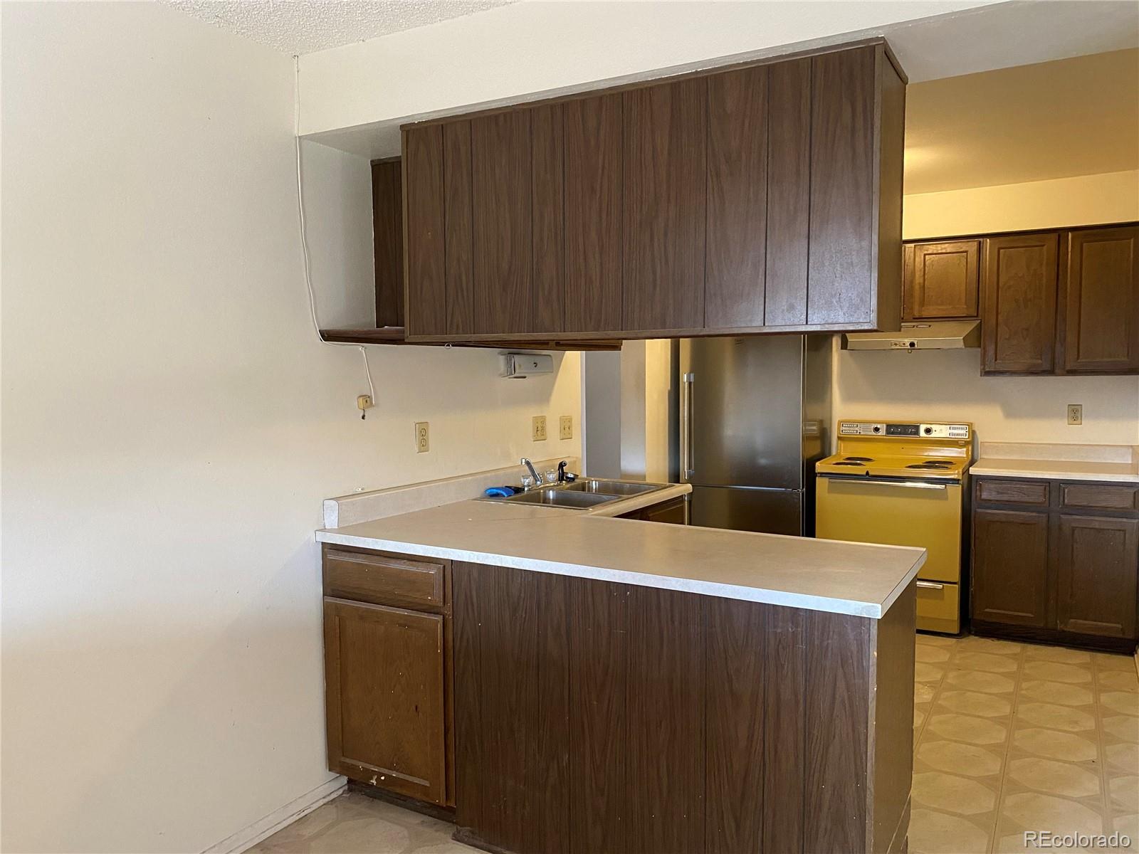 1165 Alter Way Broomfield, CO 80020 - Photo 5 of 31 a kitchen with a sink a stove and cabinets