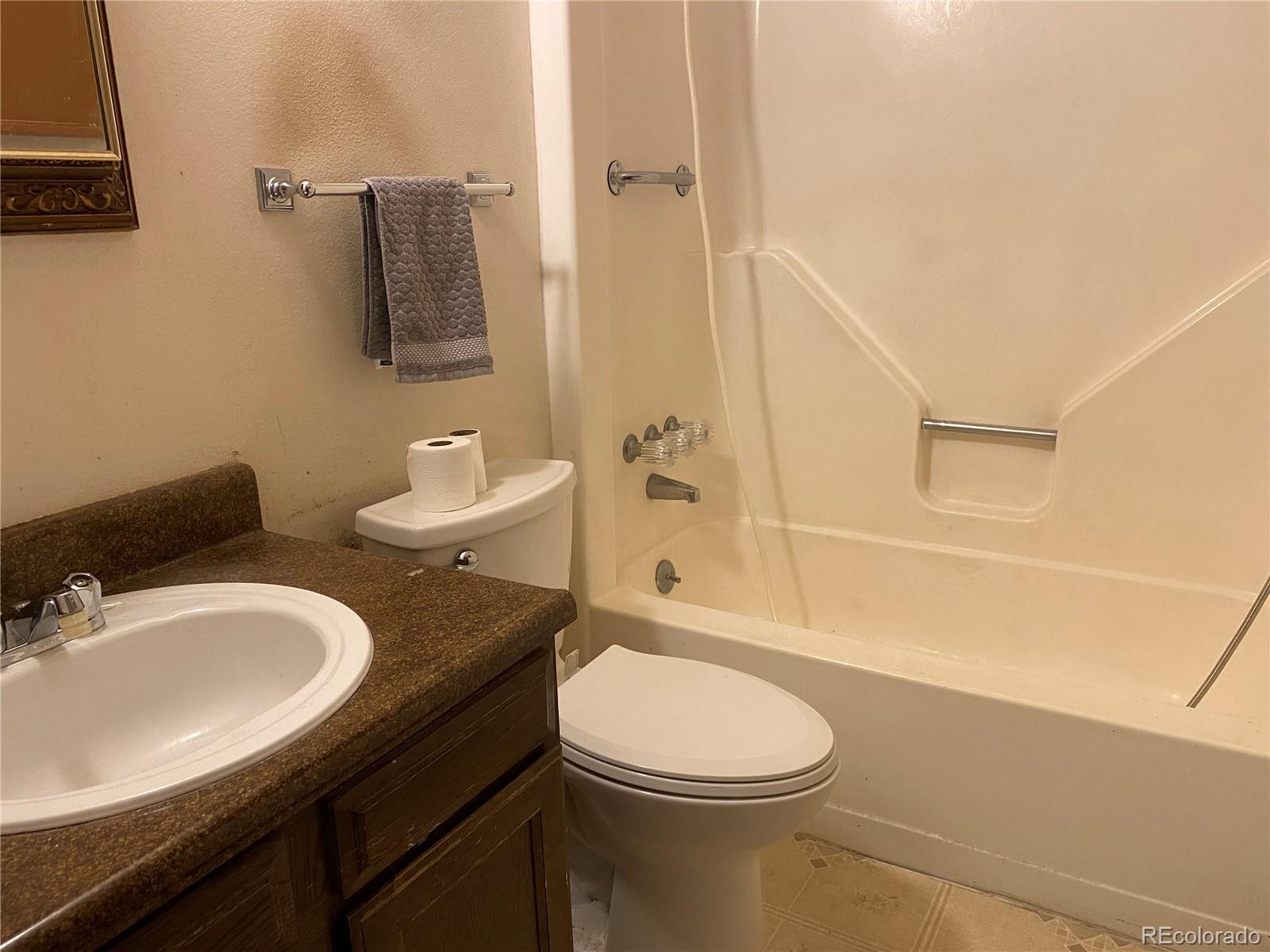 1165 Alter Way Broomfield, CO 80020 - Photo 8 of 31 a bathroom with a granite countertop sink toilet and shower