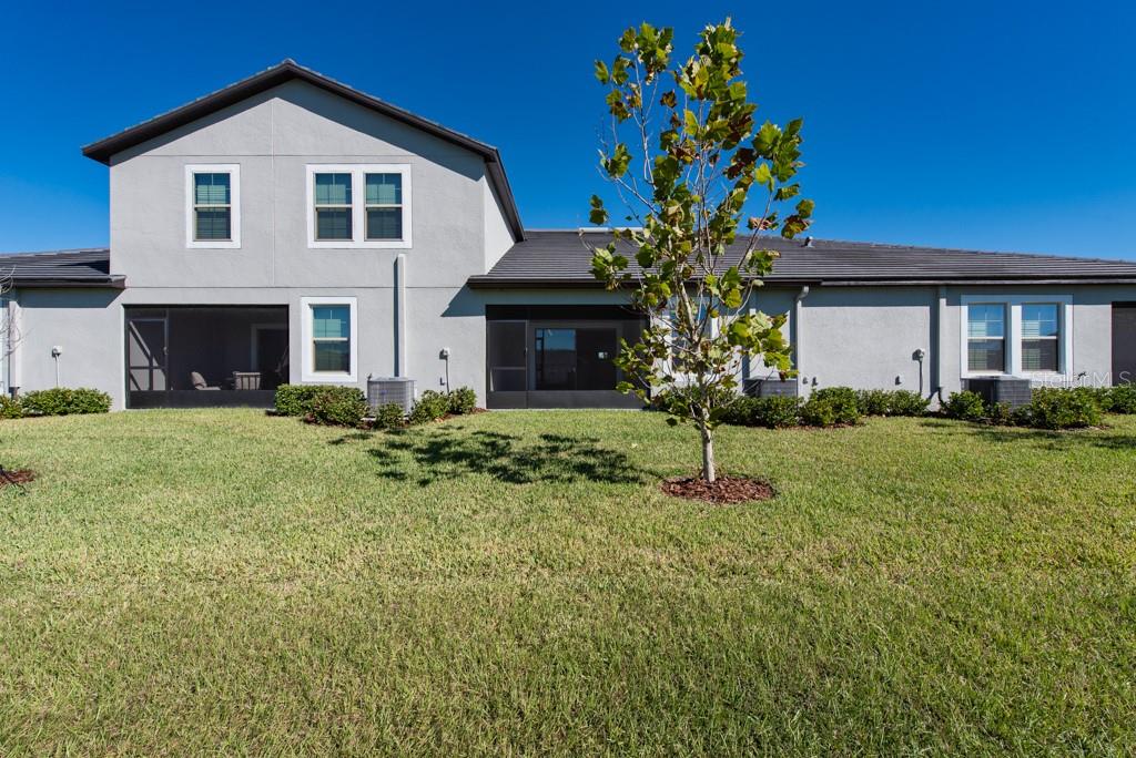 10976 Gable Dig Loop San Antonio, FL 33576 - Photo 25 of 37 a front view of a house with garden