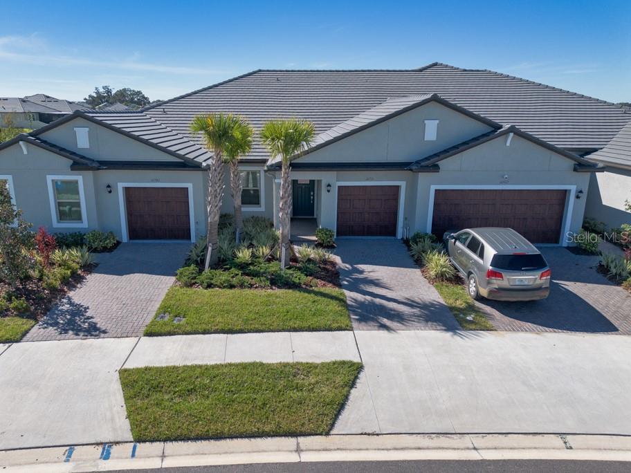 10976 Gable Dig Loop San Antonio, FL 33576 - Photo 4 of 37 a front view of house with yard and outdoor seating