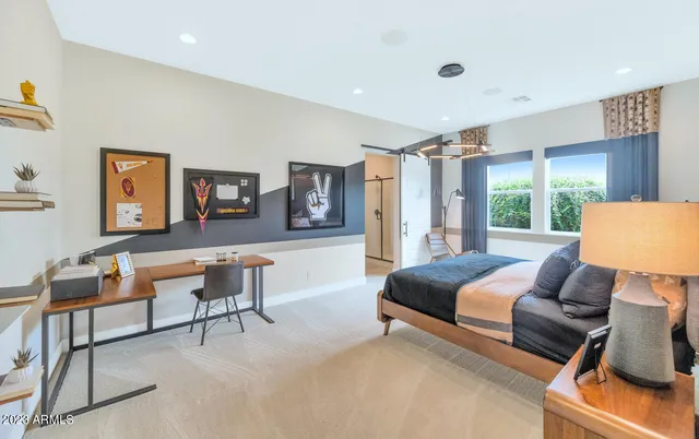 a bedroom with a bed and a mirror