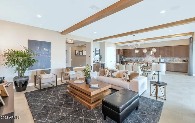 a view of a dining room and livingroom with furniture and a kitchen view