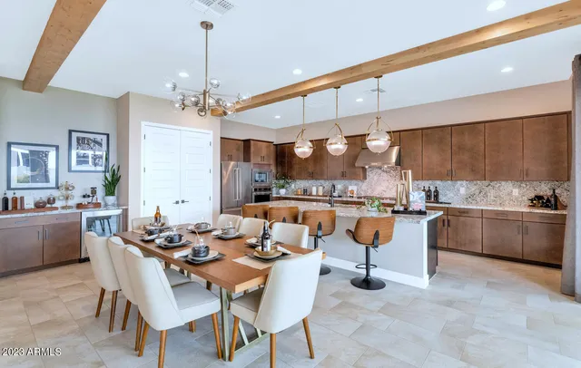 a room with stainless steel appliances kitchen island granite countertop lots of counter top space