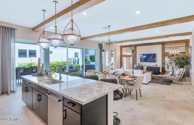 a spacious bedroom with a large bed and a potted plant