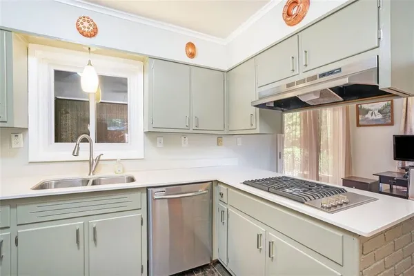 a kitchen with stainless steel appliances granite countertop a sink and a stove