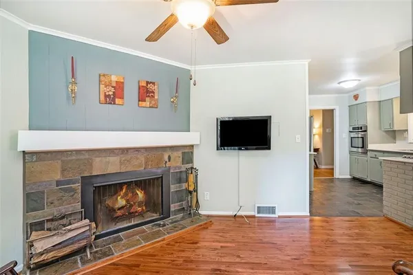 a living room with furniture a flat screen tv and a fireplace