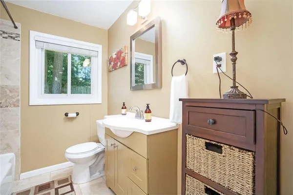 a bathroom with a sink toilet and mirror