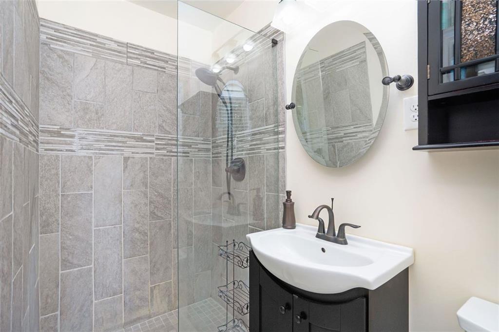 1220 Blueberry Trail Decatur, GA 30033 - Photo 25 of 30 a bathroom with a sink a mirror a vanity and shower