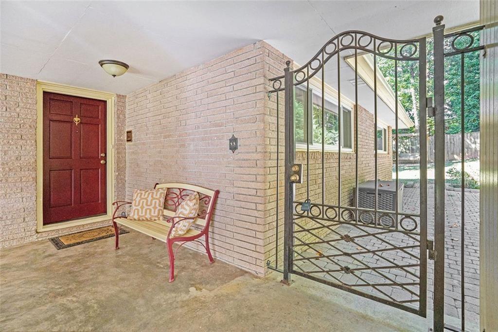 1220 Blueberry Trail Decatur, GA 30033 - Photo 6 of 30 a view of a brick house with a bench and bench