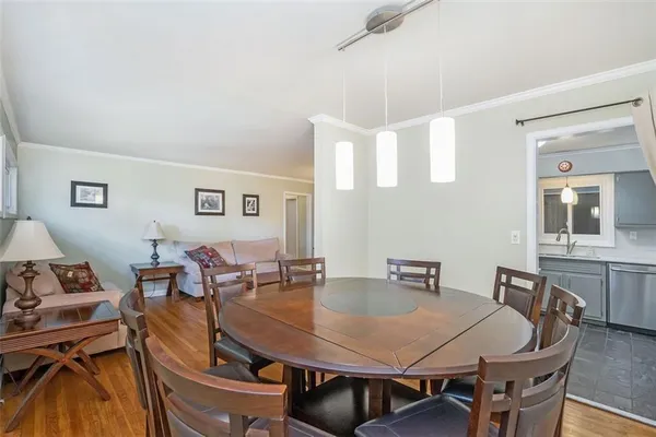 a view of a dining room with furniture and wooden floor