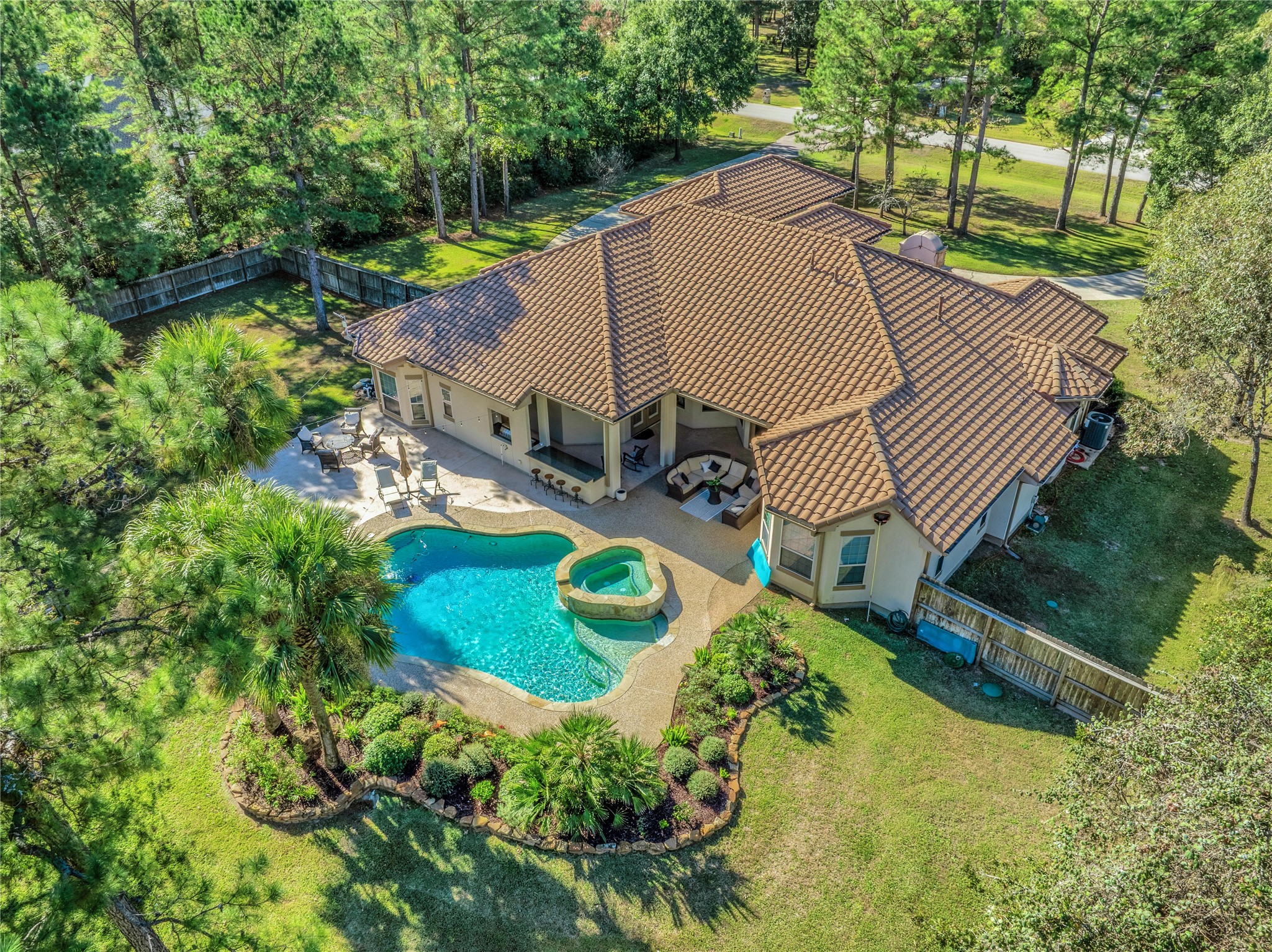 a view of a backyard with plants and a patio