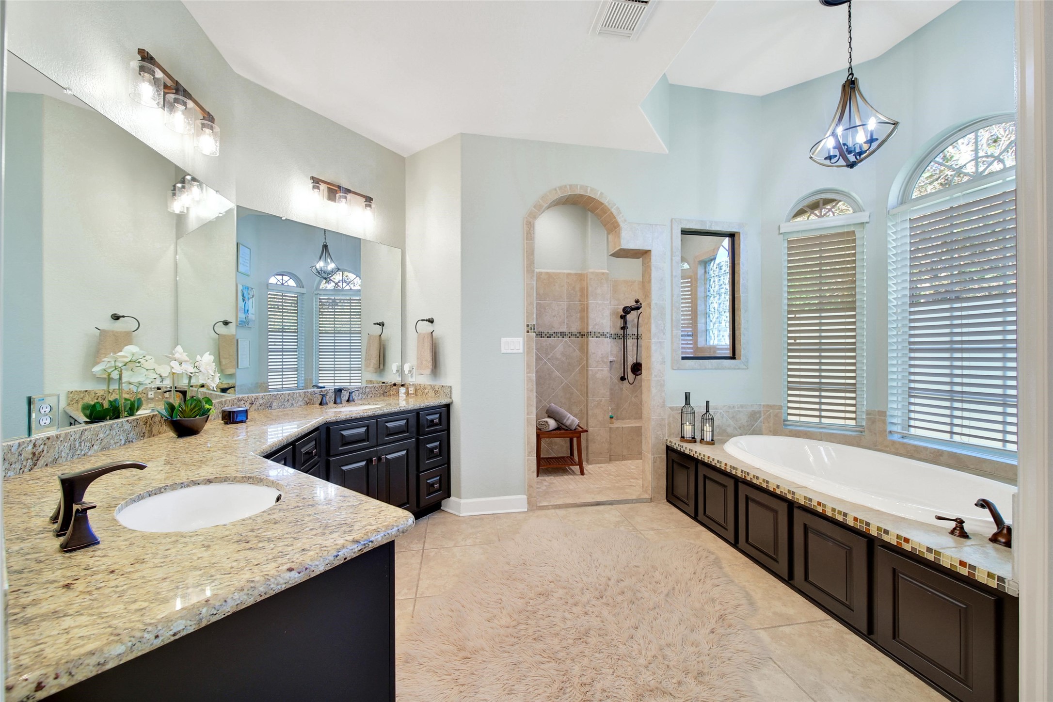 26122 Crown Ranch Boulevard Montgomery, TX 77316 - Photo 14 of 31 a spacious bathroom with a granite countertop tub a double vanity sink and a mirror