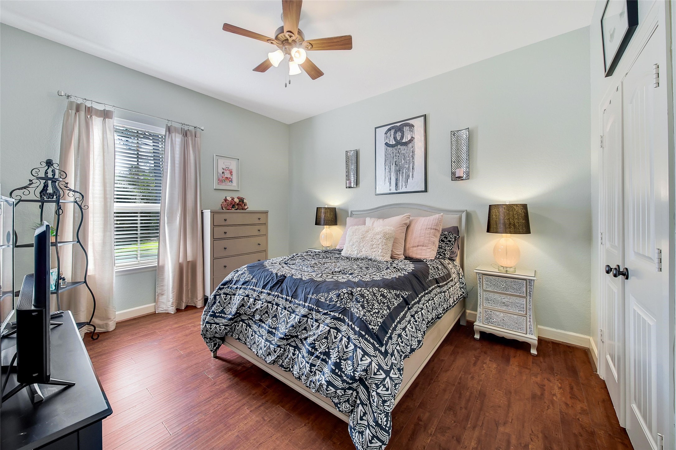 26122 Crown Ranch Boulevard Montgomery, TX 77316 - Photo 20 of 31 a bedroom with a bed and a flat tv screen on the dresser