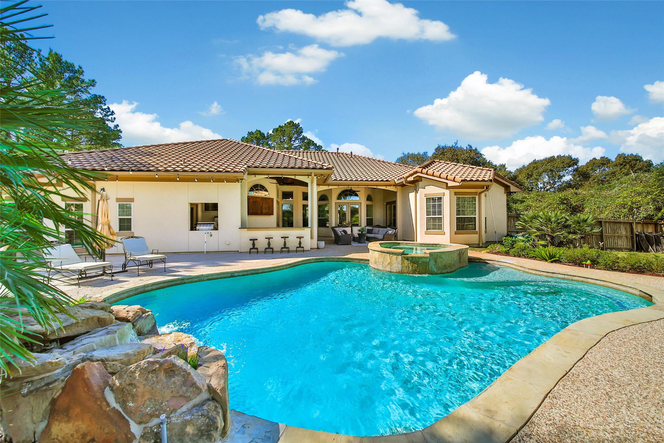 26122 Crown Ranch Boulevard Montgomery, TX 77316 - Photo 28 of 31 a front view of a house with swimming pool having outdoor seating