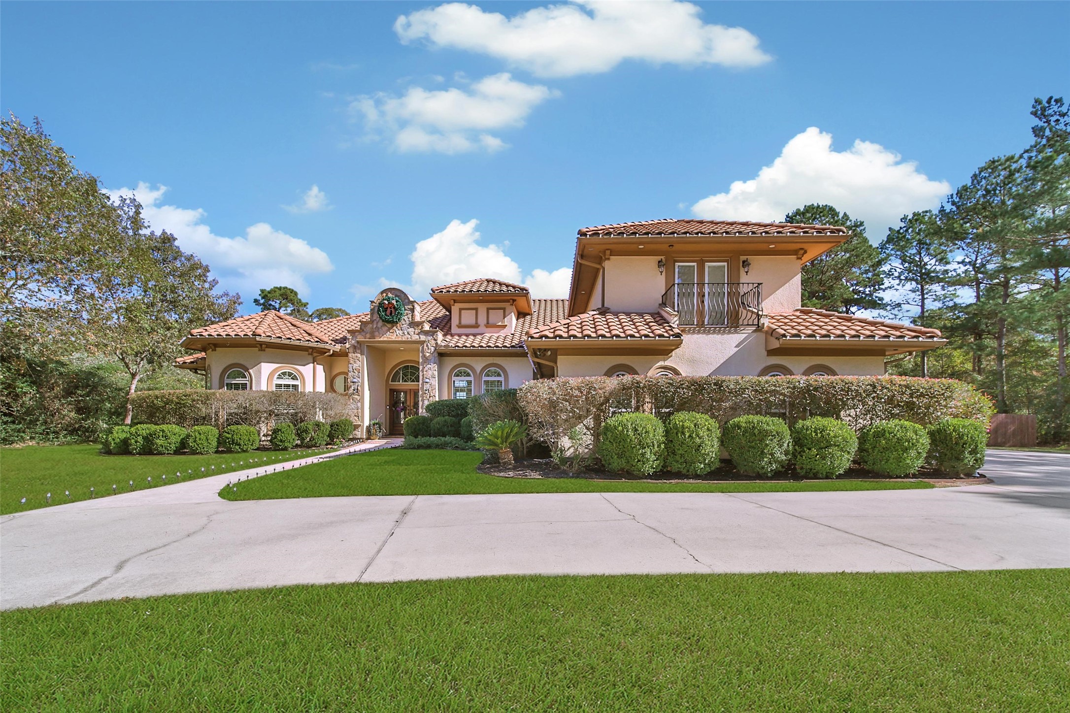 26122 Crown Ranch Boulevard Montgomery, TX 77316 - Photo 3 of 31 a front view of a house with a yard and potted plants