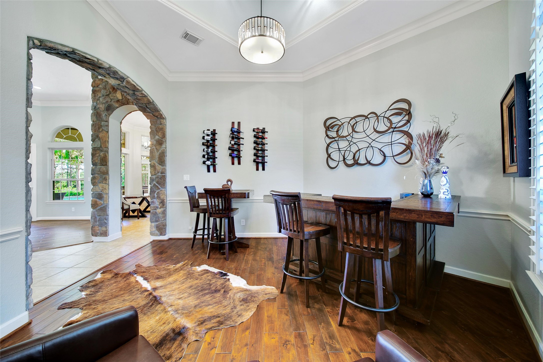 26122 Crown Ranch Boulevard Montgomery, TX 77316 - Photo 5 of 31 a view of a dining room with furniture a chandelier and wooden floor