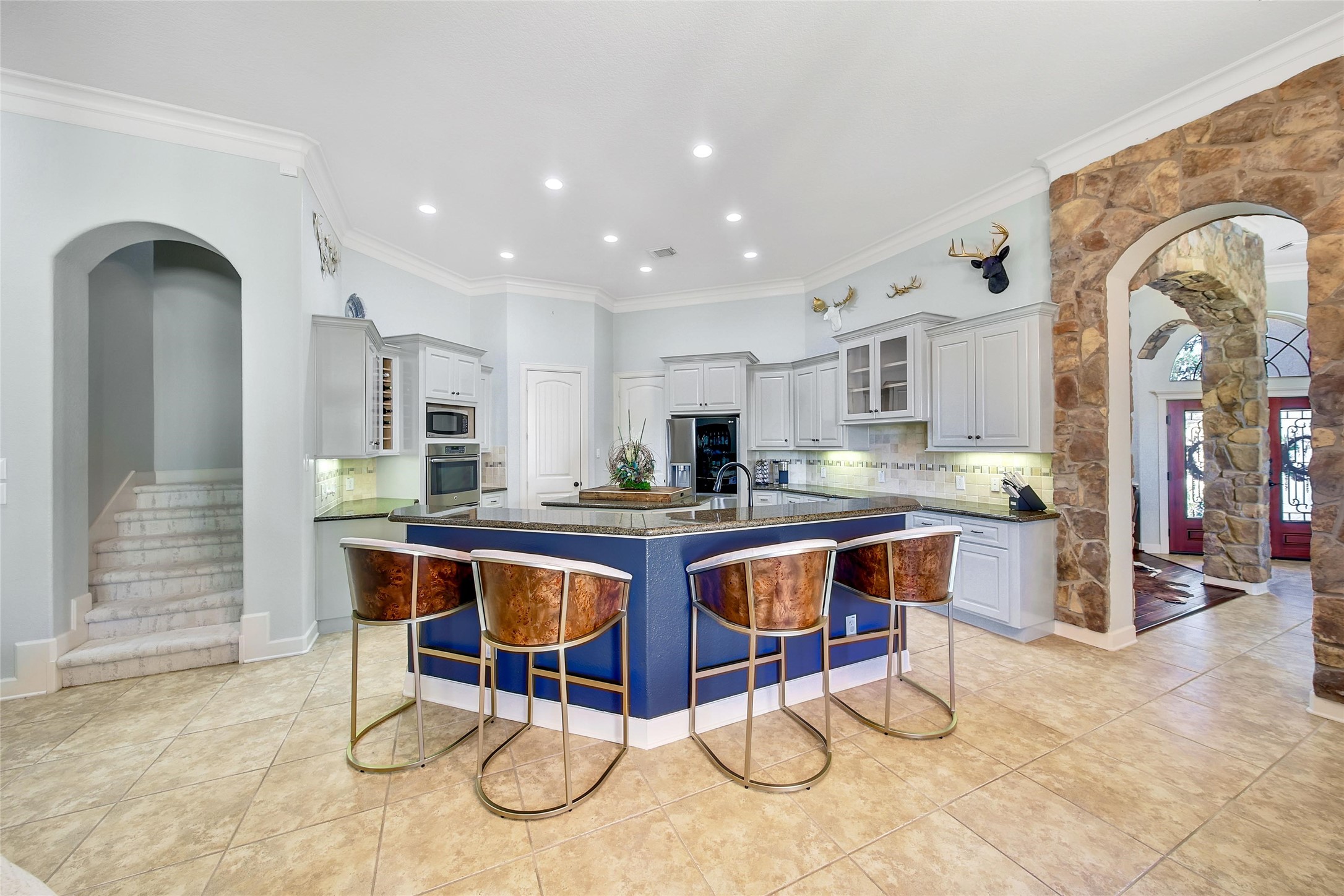 26122 Crown Ranch Boulevard Montgomery, TX 77316 - Photo 7 of 31 a kitchen with stainless steel appliances granite countertop a dining table and chairs