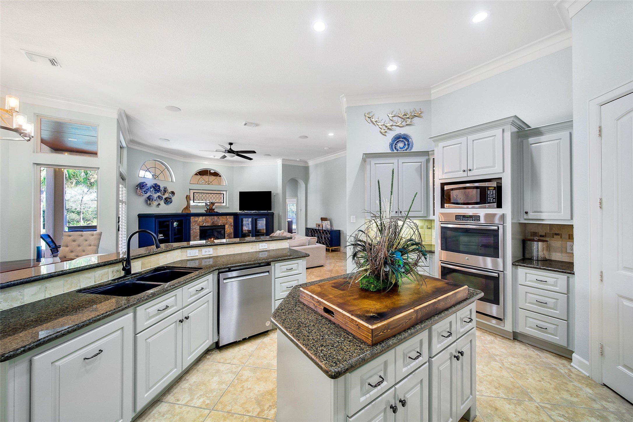26122 Crown Ranch Boulevard Montgomery, TX 77316 - Photo 9 of 31 a kitchen with kitchen island a sink stove and refrigerator