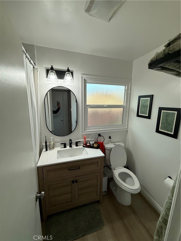 12042 Hackamore Road Garden Grove, CA 92840 - Photo 12 of 20 a bathroom with a toilet sink and mirror